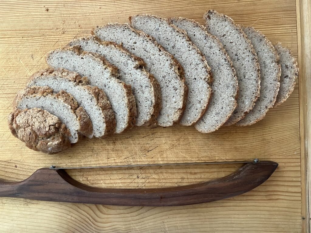 Wheat Free Buckwheat Sourdough Wheat free buckwheat sourdough loaf, sliced and fanned out on a wooden board